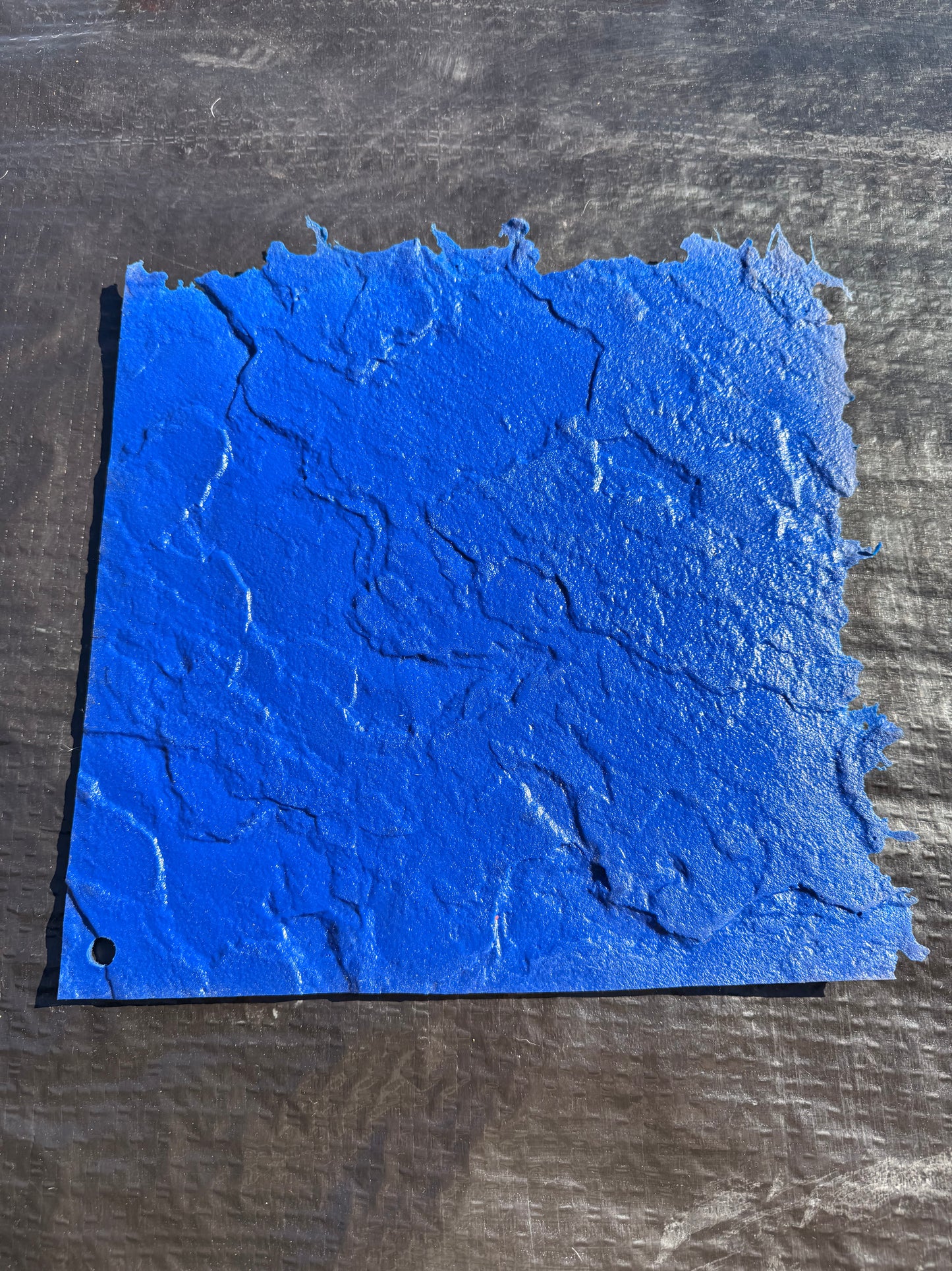 blue square concrete mat on top of a black background
