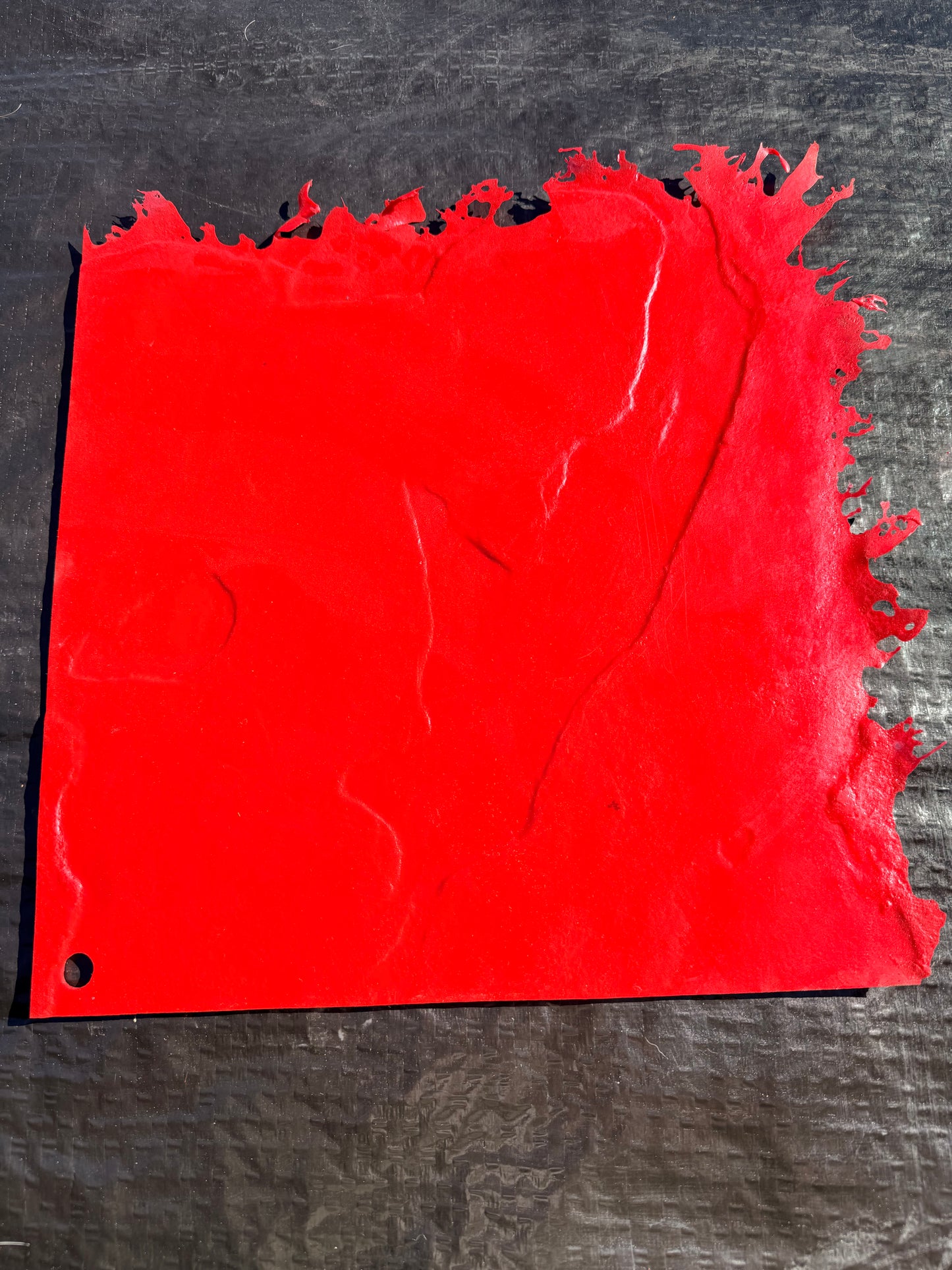 red square concrete mat on top of a black background