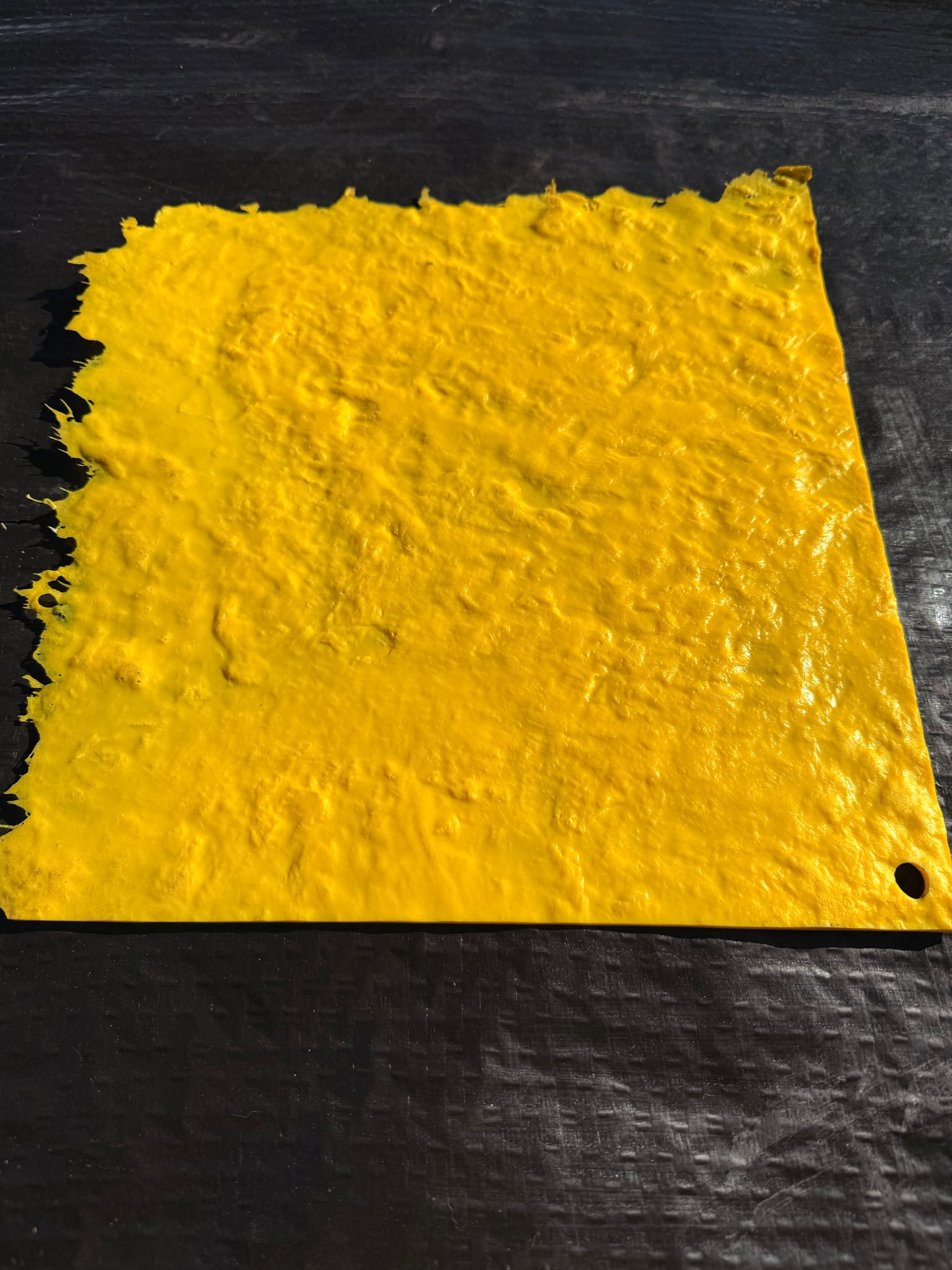 Yellow textured mat on a black background