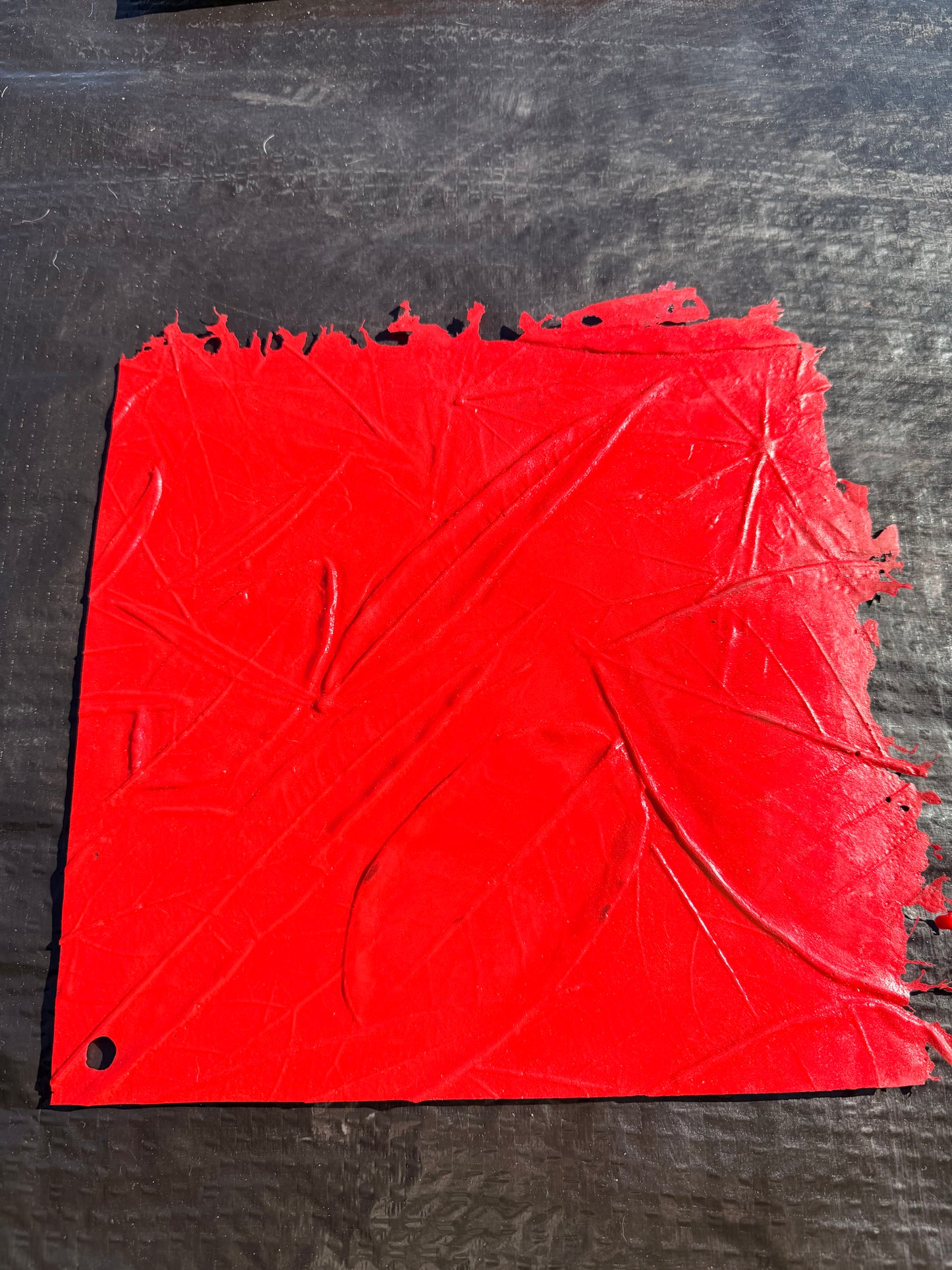 red square concrete mat on top of a black surface