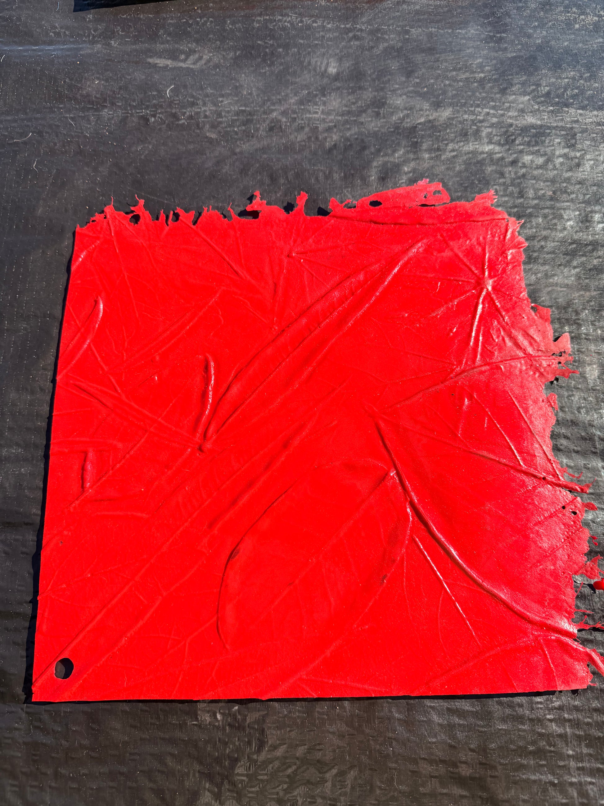 red square concrete mat on top of a black surface