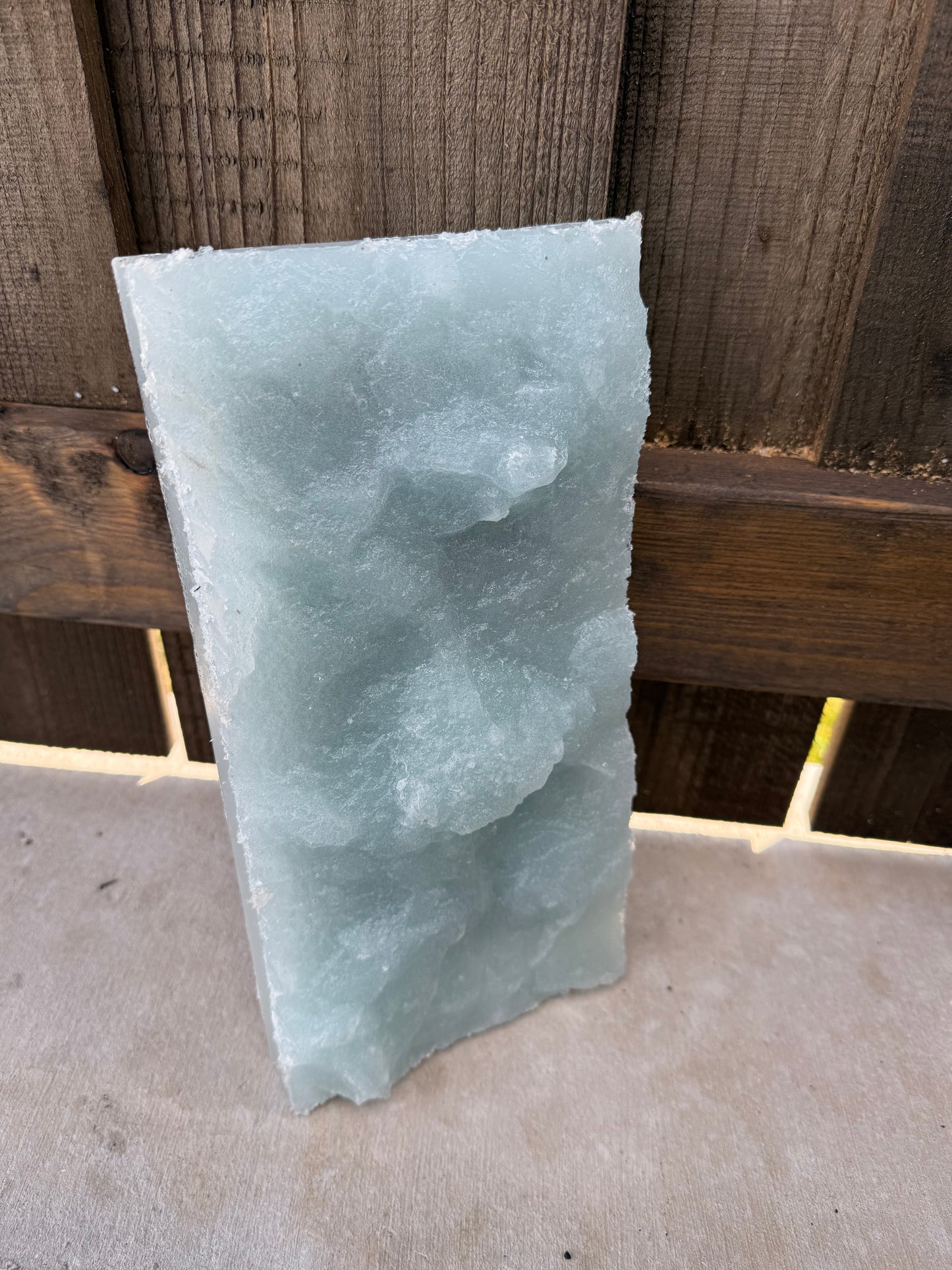 Rectangular textured trowel of light blue gabbro on a concrete  surface