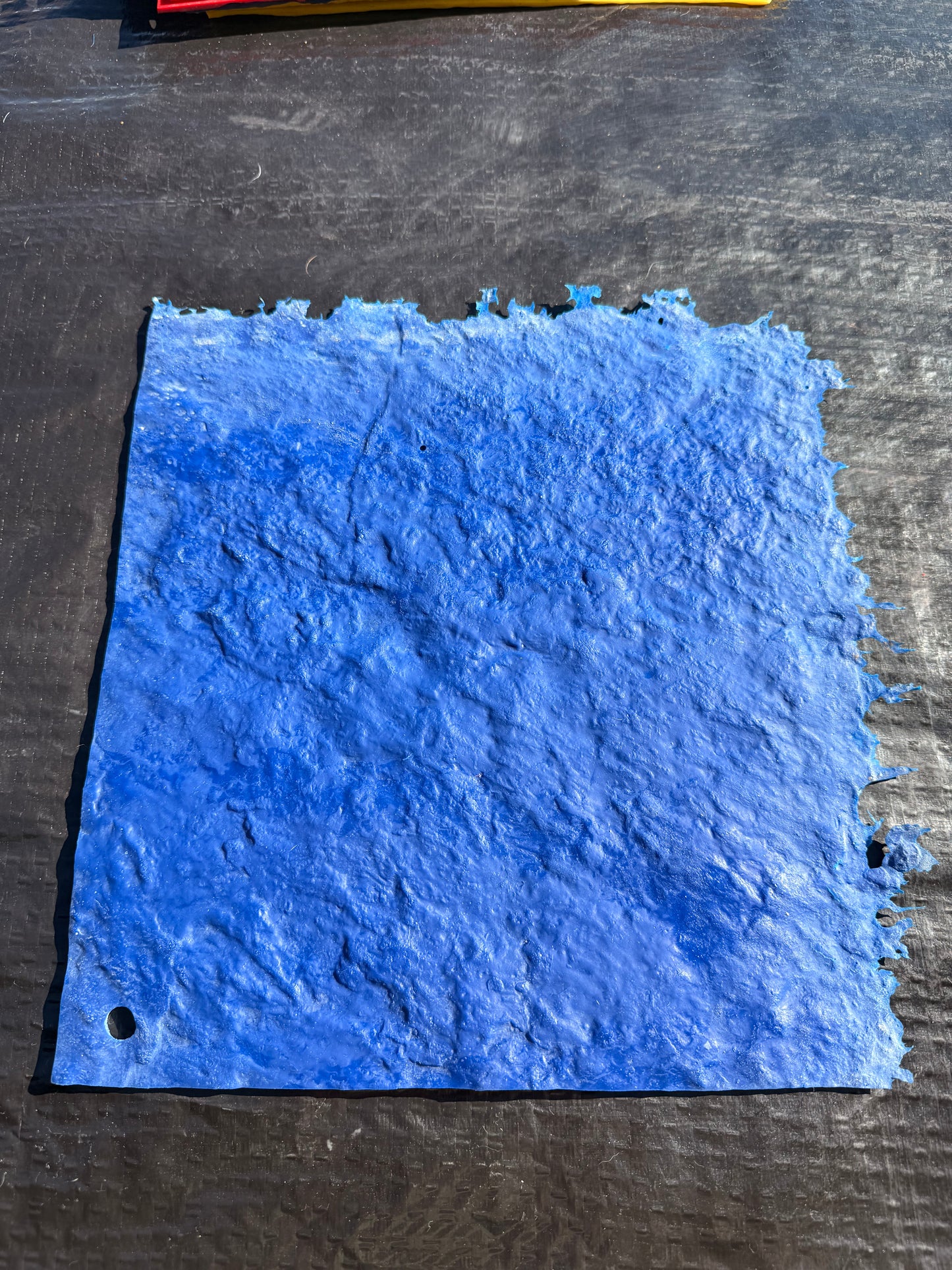 blue square mat on top of a black background