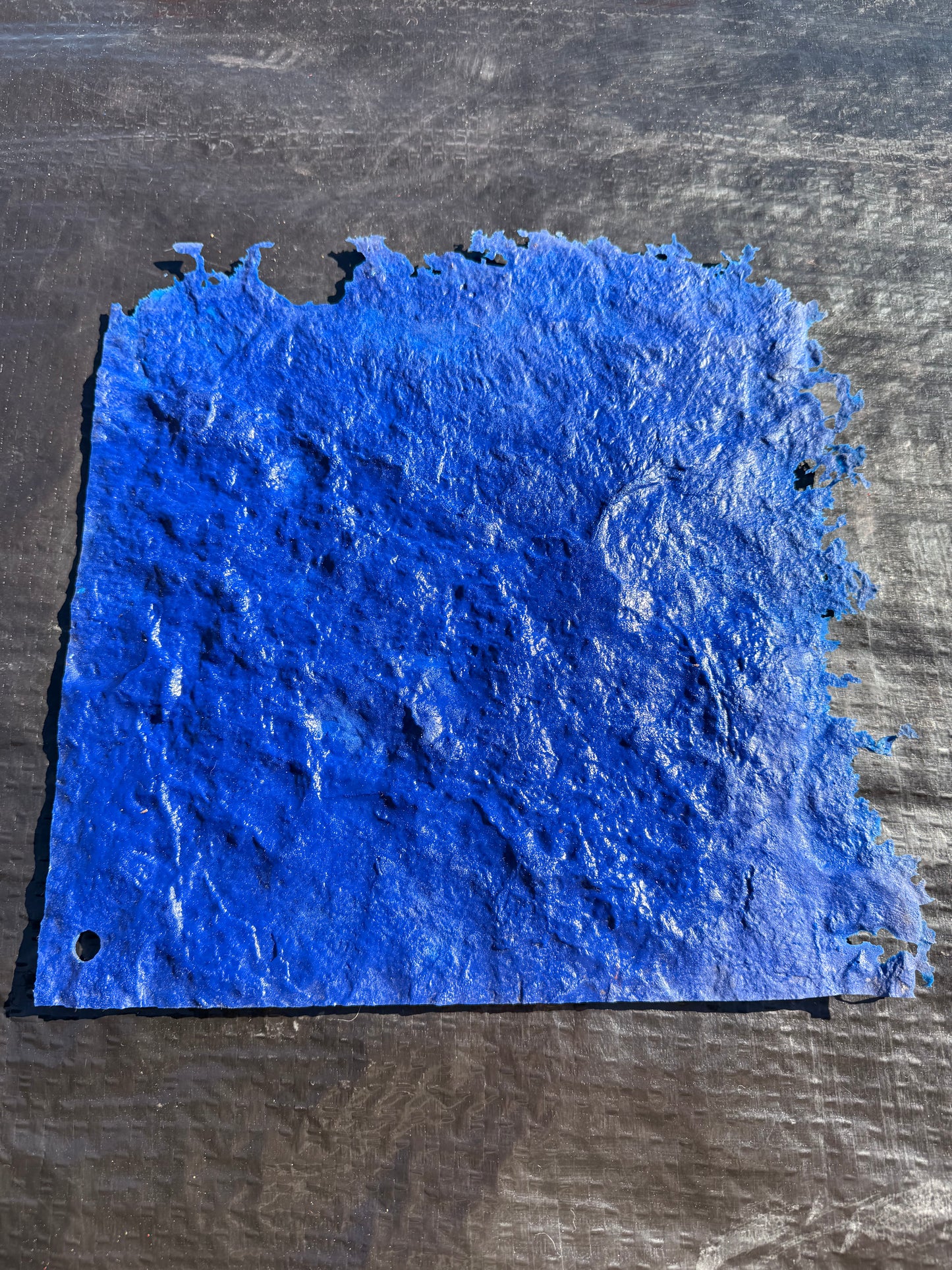 Blue textured material on a black surface