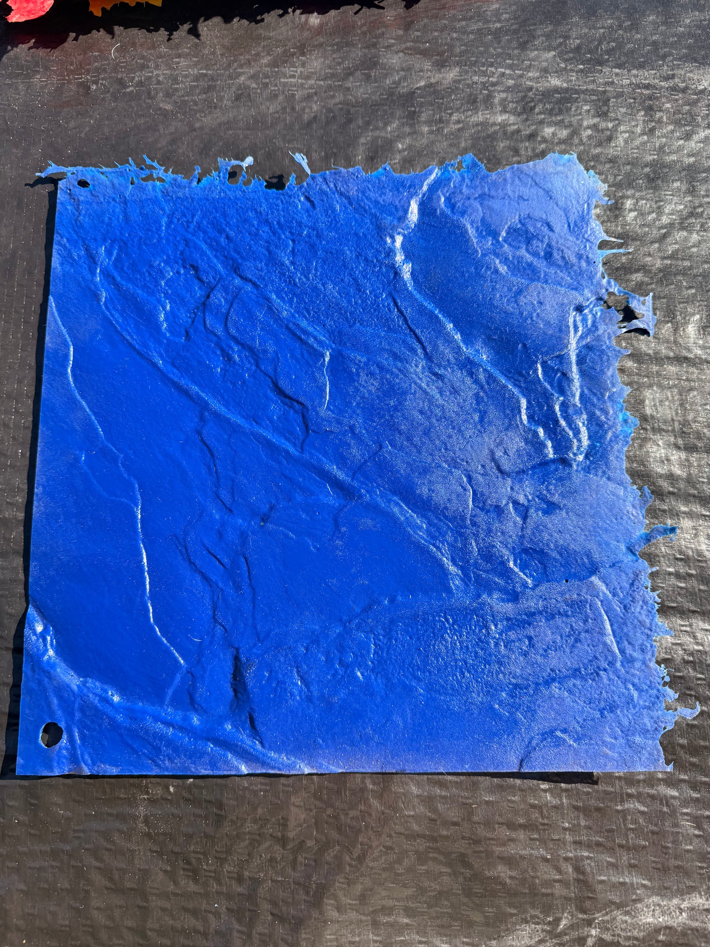 blue square mat on top of a black surface