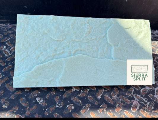 light green rectangle textured trowel on top of a black metal plate. with a logo saying Sierra split on it. 
