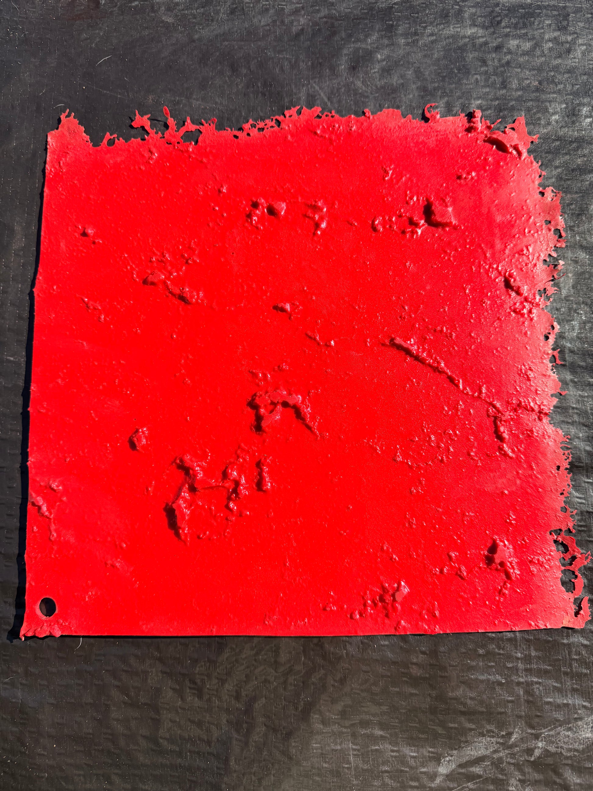 red square concrete mat on a black surface